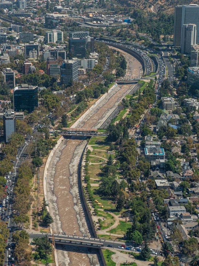 Aerial shot of Santiago, Chile featuring the cityscape and river winding through urban areas.